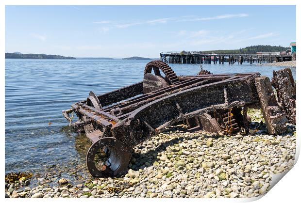 Abandoned Machinery  on the beach of Alert Bay with an old disused pier behind behind, British Columbia, Canada Print by Dave Collins