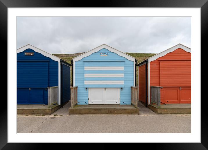 Colourful beach huts shut for winter, Gorleston, Norfolk, England Framed Mounted Print by Dave Collins