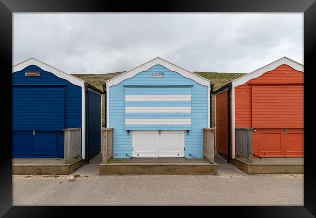 Colourful beach huts shut for winter, Gorleston, Norfolk, England Framed Print by Dave Collins