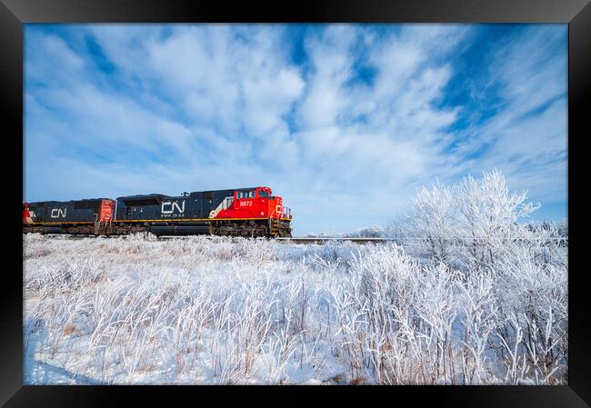 Train Passing a Snowy Landscape Framed Print by Dave Reede