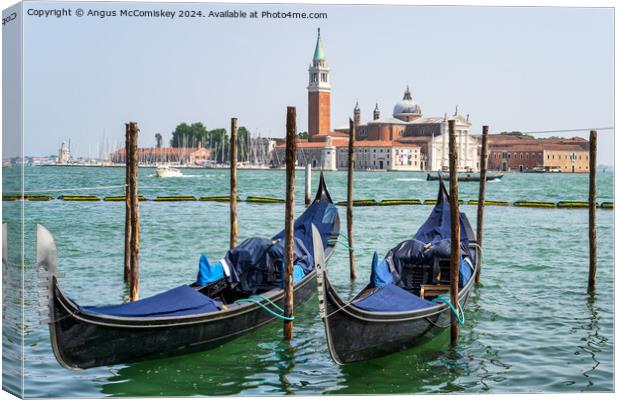 Gondolas on waterfront promenade in Venice Canvas Print by Angus McComiskey