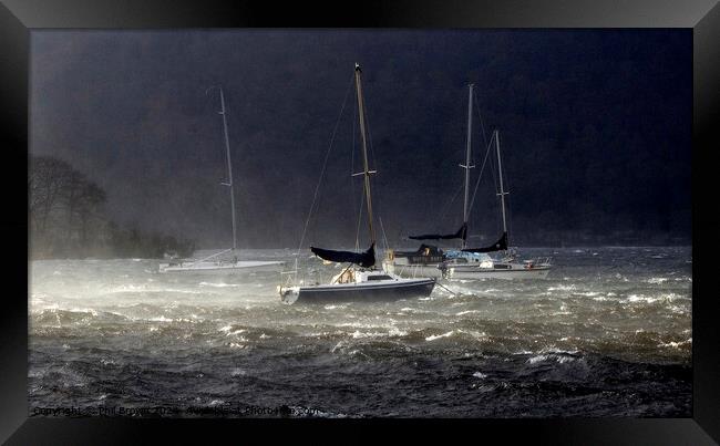 Storms on Windermere for moored yachts. Framed Print by Phil Brown
