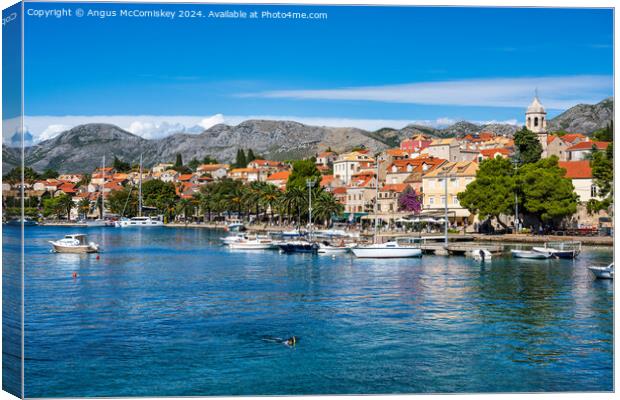 Boats moored in Cavtat harbour in Croatia Canvas Print by Angus McComiskey