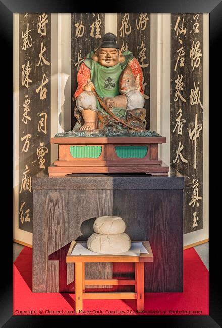 Wooden statue of Ebisu above a kagami-mochi rice cake. Framed Print by  Kuremo