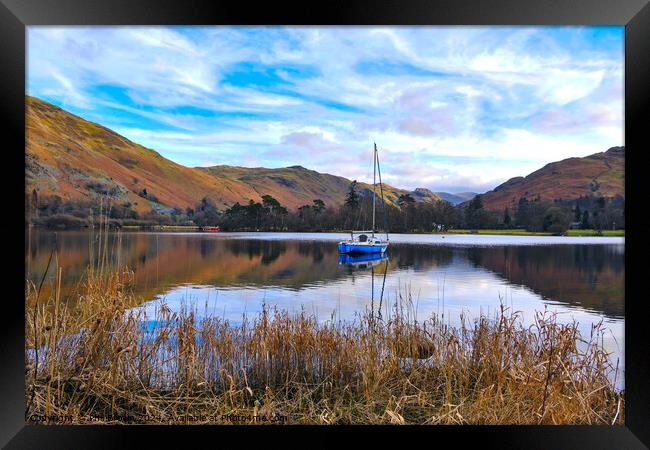 A yacht moored on Ullswater, Lake District, Cumbria. Framed Print by Phil Brown