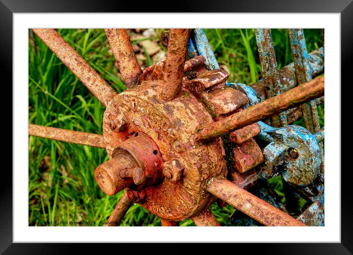 Very rusty horse drawn, hay rake wheel hub. Framed Mounted Print by Phil Brown