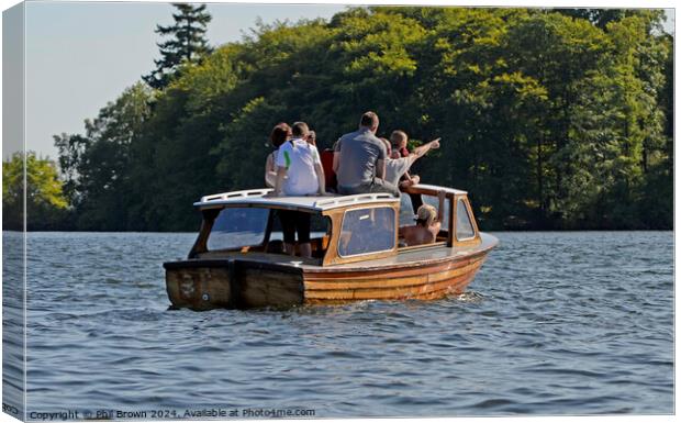 Family on small wooden motor launch, Windermere, Lake District. Canvas Print by Phil Brown