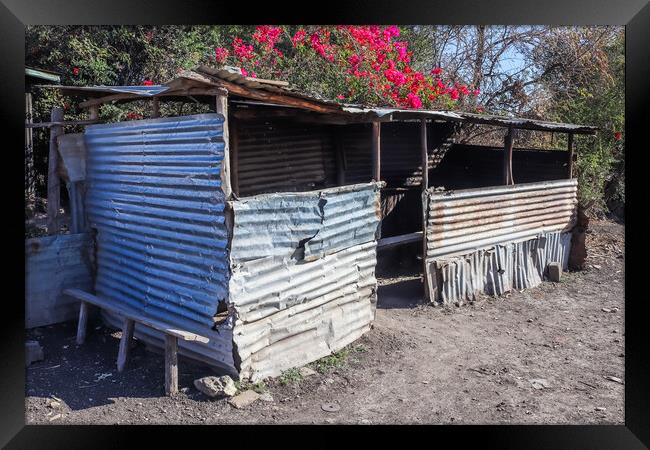 Old abandoned huts on the side of African roads in poor regions. Framed Print by Michael Piepgras