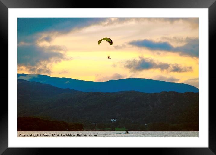 Paraglider flies above Windermere at dusk. Framed Mounted Print by Phil Brown