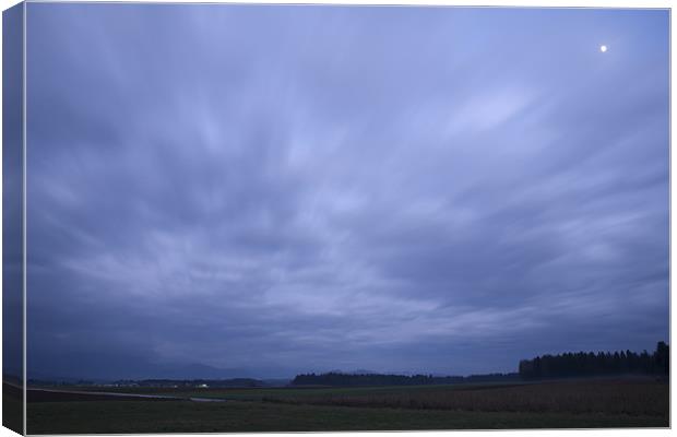 Storm clouds at dusk Canvas Print by Ian Middleton