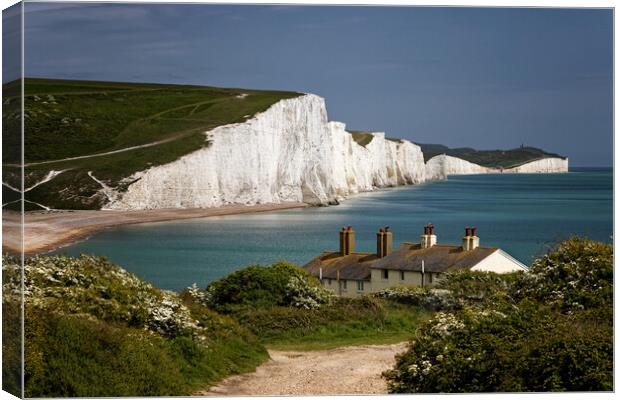 The Seven Sisters cliffs and the Coastguards Cottages at Cuckmere Haven near Eastbourne in East Sussex UK Canvas Print by John Gilham