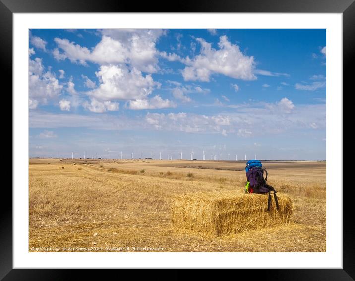 Backpack on a haystack -  Hornillos del Camino  Framed Mounted Print by Laszlo Konya