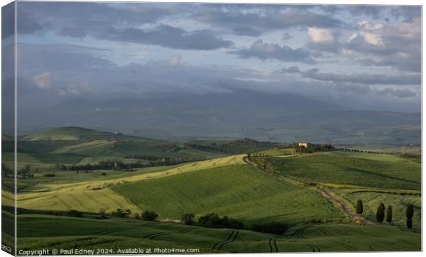 Lighting up the gloom over farmland in Tuscany, It Canvas Print by Paul Edney
