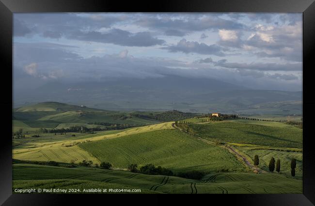 Lighting up the gloom over farmland in Tuscany, It Framed Print by Paul Edney