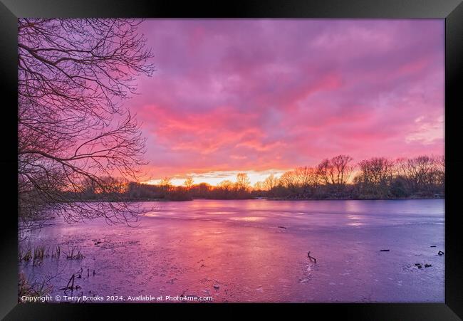 Sunset over Frozen Lake Framed Print by Terry Brooks