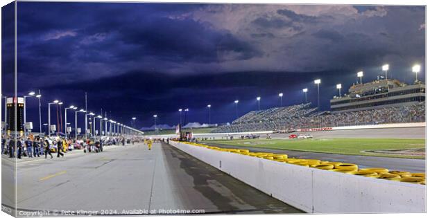 Storm clouds over a Speedway pit lane Canvas Print by Pete Klinger