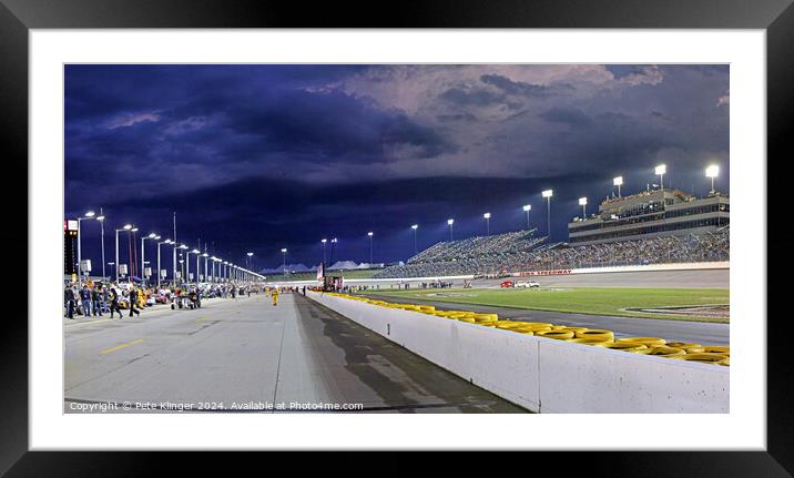 Storm clouds over a Speedway pit lane Framed Mounted Print by Pete Klinger