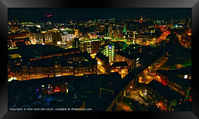 Cityscape at night with illuminated buildings and streets in Leeds, UK. Framed Print by Man And Life