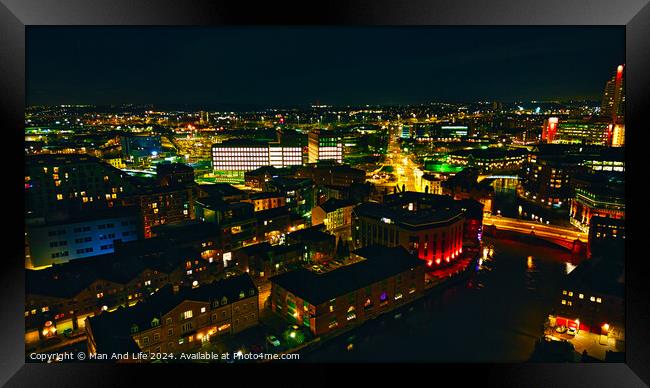 Aerial night view of a vibrant cityscape with illuminated buildings and streets in Leeds, UK. Framed Print by Man And Life