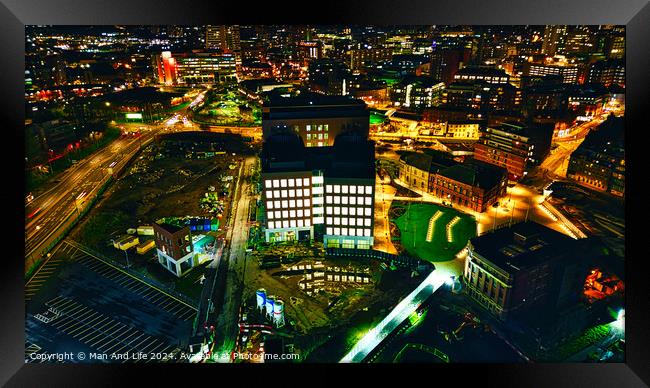 Aerial night view of an illuminated urban office building amidst city lights in Leeds, UK. Framed Print by Man And Life
