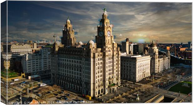 Dramatic skyline of Liverpool with iconic Liver Building at sunset, showcasing the city's architecture and urban landscape. Canvas Print by Man And Life