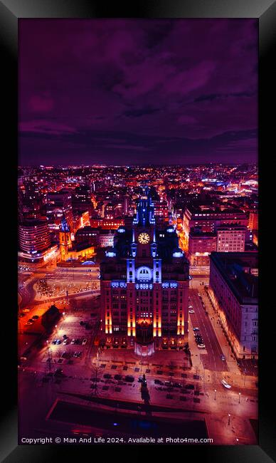 Aerial night view of a cityscape with illuminated buildings under a purple sky in Liverpool, UK. Framed Print by Man And Life