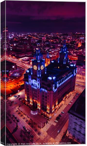 Vertical cityscape at night with illuminated historic building against a purple sky in Liverpool, UK. Canvas Print by Man And Life