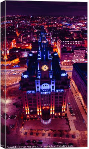 Vertical aerial view of a lit-up cityscape at night with a prominent clock tower and urban streets in Liverpool, UK. Canvas Print by Man And Life