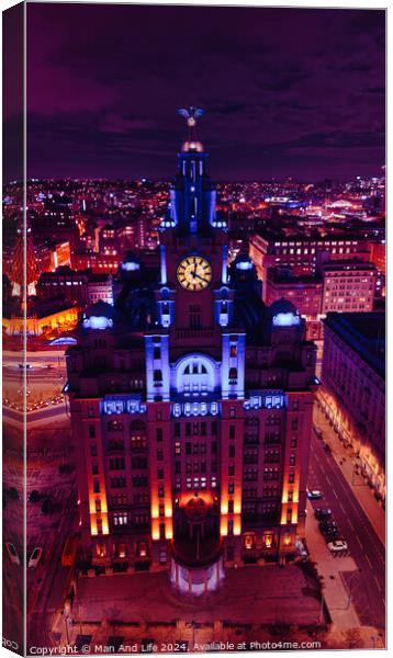 Vertical aerial view of an illuminated historic building at night with city lights in the background in Liverpool, UK. Canvas Print by Man And Life