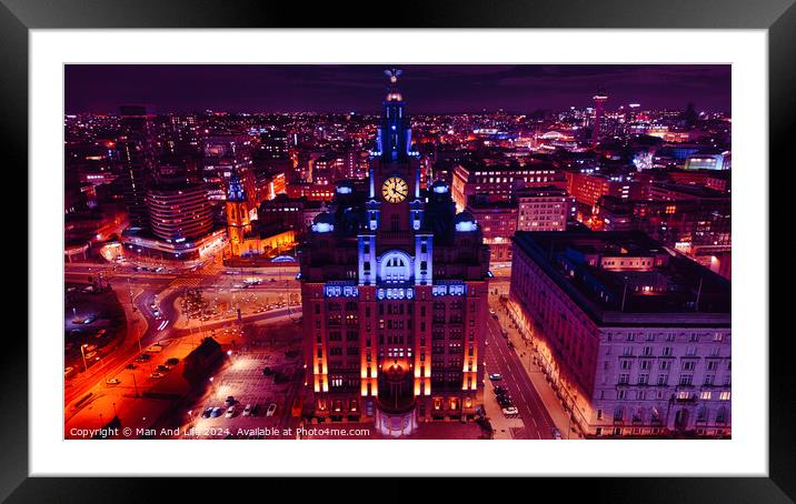 Aerial night view of an illuminated cityscape with a prominent clock tower and urban architecture in Liverpool, UK. Framed Mounted Print by Man And Life