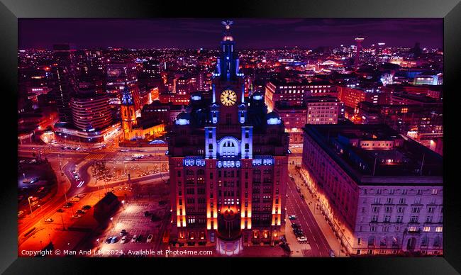 Aerial night view of an illuminated cityscape with a prominent clock tower and urban architecture in Liverpool, UK. Framed Print by Man And Life