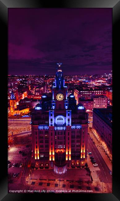 Aerial night view of an illuminated historic building in an urban landscape with vibrant purple skies in Liverpool, UK. Framed Print by Man And Life