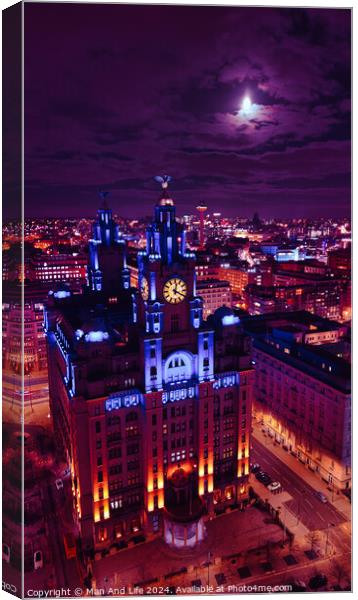 Moonlit cityscape with illuminated historic building at night, showcasing urban architecture against a dramatic sky in Liverpool, UK. Canvas Print by Man And Life