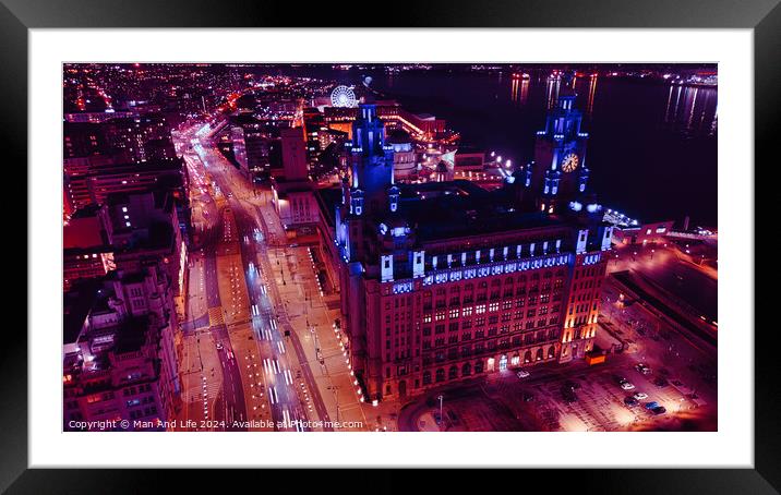 Aerial night view of an illuminated cityscape with a prominent clock tower and urban streets in Liverpool, UK. Framed Mounted Print by Man And Life