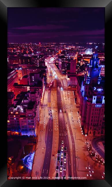 Vertical aerial view of a bustling city street at night with vibrant purple lighting and traffic trails in Liverpool, UK. Framed Print by Man And Life