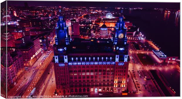 Aerial night view of an illuminated historic building in an urban setting with city lights in the background in Liverpool, UK. Canvas Print by Man And Life