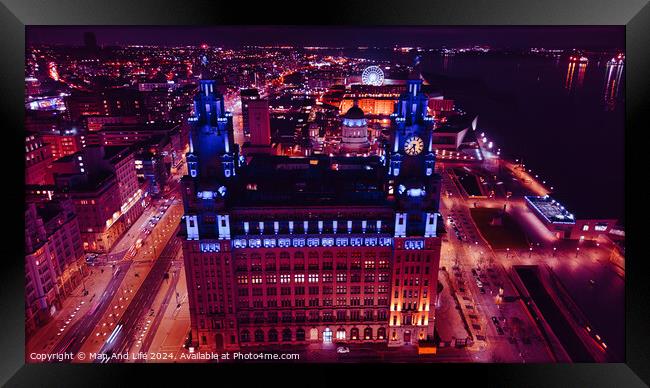 Aerial night view of an illuminated historic building in an urban setting with city lights in the background in Liverpool, UK. Framed Print by Man And Life