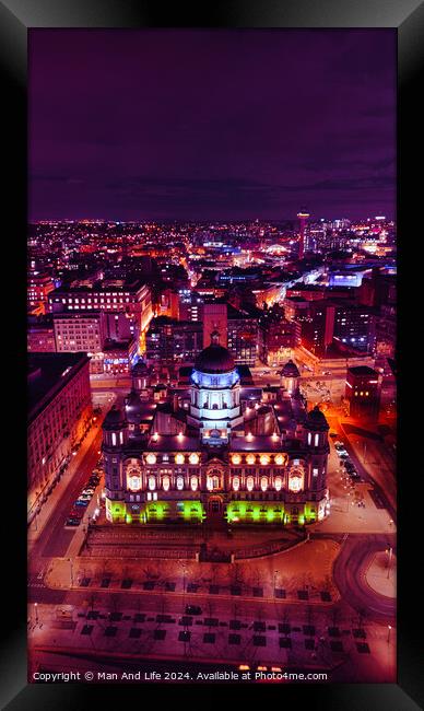 Aerial night view of a cityscape with illuminated buildings and vibrant urban lights in Liverpool, UK. Framed Print by Man And Life