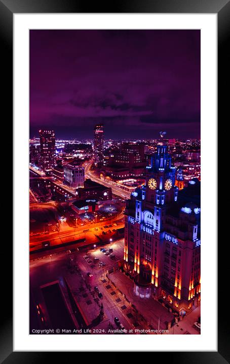 Aerial night view of a vibrant cityscape with illuminated streets and buildings under a purple sky in Liverpool, UK. Framed Mounted Print by Man And Life