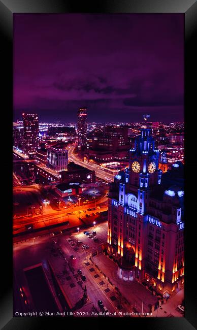 Aerial night view of a vibrant cityscape with illuminated streets and buildings under a purple sky in Liverpool, UK. Framed Print by Man And Life