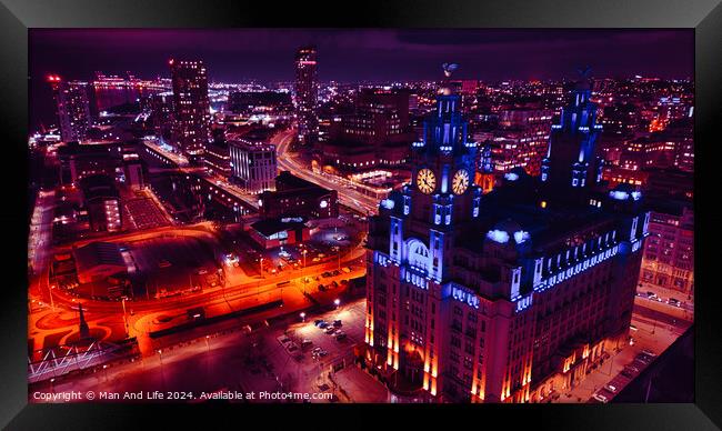 Aerial night view of a vibrant cityscape with illuminated streets and an iconic building in Liverpool, UK. Framed Print by Man And Life