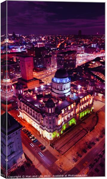 Aerial night view of an illuminated historic building in an urban setting, showcasing vibrant city lights and architecture in Liverpool, UK. Canvas Print by Man And Life