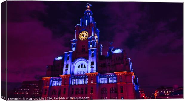 Liverpool's iconic Royal Liver Building at night, illuminated in vibrant purple light against a dark sky. Canvas Print by Man And Life