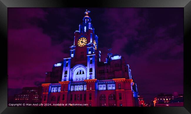 Liverpool's iconic Royal Liver Building at night, illuminated in vibrant purple light against a dark sky. Framed Print by Man And Life