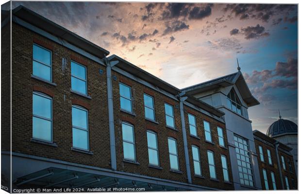 Classic building facade against a dramatic sunset sky with clouds. Canvas Print by Man And Life
