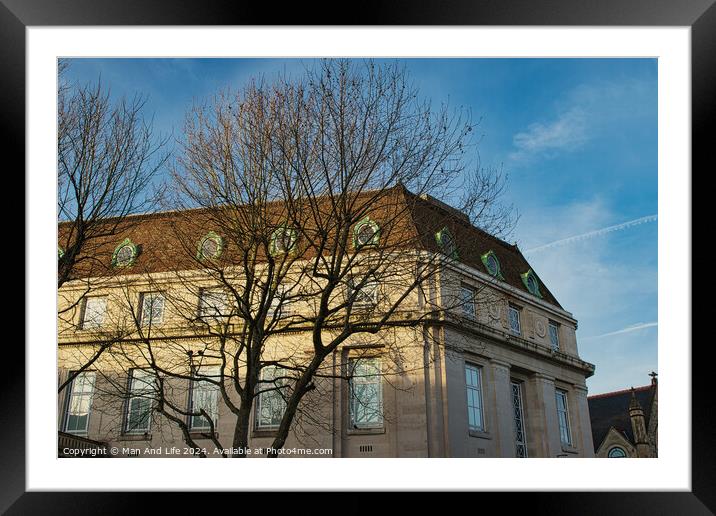Classic European building facade with bare tree branches against a clear blue sky at dusk. Framed Mounted Print by Man And Life