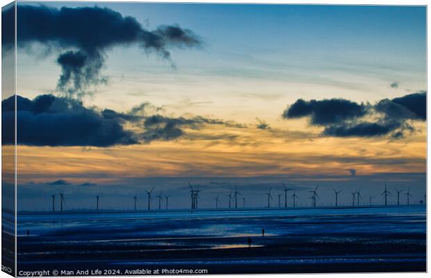 Serene sunset over a wind farm with silhouettes of turbines and dramatic clouds, reflecting on water in Crosby, England. Canvas Print by Man And Life