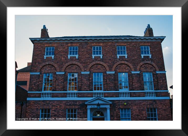 Traditional brick building facade under blue sky at dusk in York, UK. Framed Mounted Print by Man And Life