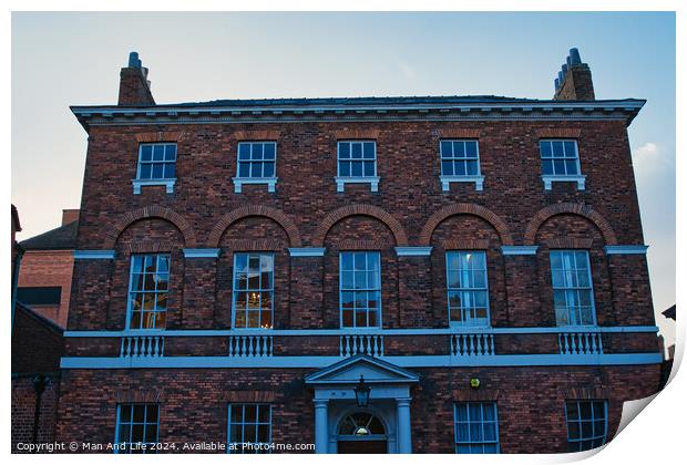 Traditional brick building facade under blue sky at dusk in York, UK. Print by Man And Life