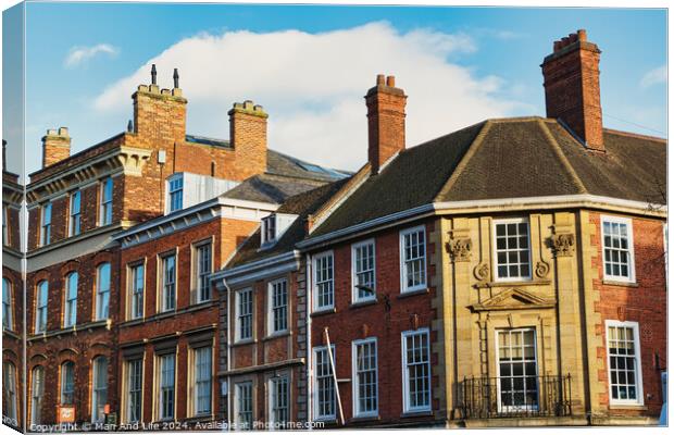 Historic brick buildings with classic British architecture under a clear blue sky in York, UK. Canvas Print by Man And Life